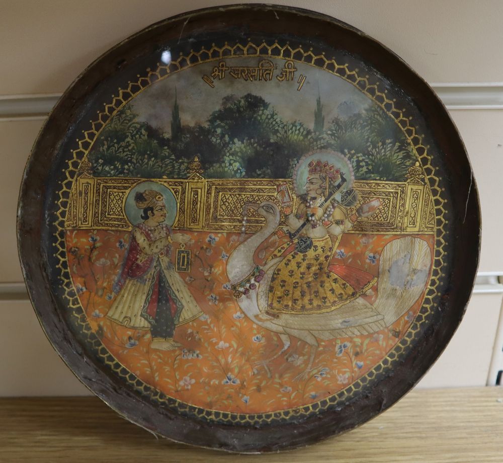 19th century Indian School, gouache on parchment?, Deity riding a white peacock and attendant, heightened with gilt, tondo, set into a